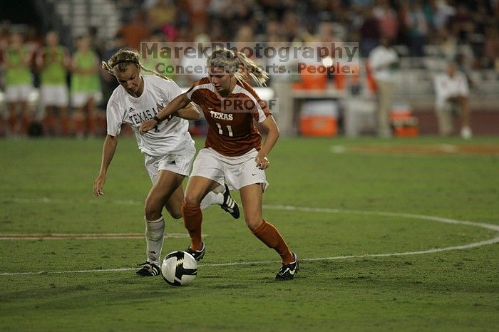 UT sophomore Niki Arlitt (#11, Forward) steals the ball from an Aggie.  The University of Texas women's soccer team tied 0-0 against the Texas A&M Aggies Friday night, September 27, 2008.

Filename: SRM_20080926_2056087.jpg
Aperture: f/2.8
Shutter Speed: 1/640
Body: Canon EOS-1D Mark II
Lens: Canon EF 300mm f/2.8 L IS