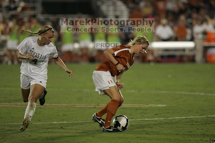 UT sophomore Niki Arlitt (#11, Forward) steals the ball from an Aggie.  The University of Texas women's soccer team tied 0-0 against the Texas A&M Aggies Friday night, September 27, 2008.

Filename: SRM_20080926_2056109.jpg
Aperture: f/2.8
Shutter Speed: 1/640
Body: Canon EOS-1D Mark II
Lens: Canon EF 300mm f/2.8 L IS