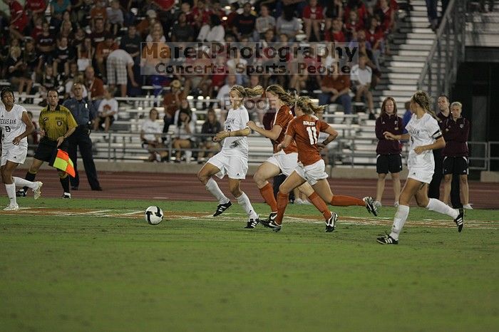 UT freshman Courtney Goodson (#7, Forward and Midfielder) tries to steal the ball as UT sophomore Niki Arlitt (#11, Forward) watches.  The University of Texas women's soccer team tied 0-0 against the Texas A&M Aggies Friday night, September 27, 2008.

Filename: SRM_20080926_2056505.jpg
Aperture: f/2.8
Shutter Speed: 1/640
Body: Canon EOS-1D Mark II
Lens: Canon EF 300mm f/2.8 L IS