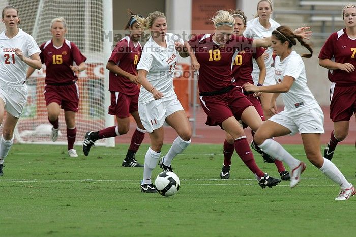 UT sophomore Niki Arlitt (#11, Forward) passes the ball to UT sophomore Alisha Ortiz (#12, Forward).  The University of Texas women's soccer team won 2-1 against the Iowa State Cyclones Sunday afternoon, October 5, 2008.

Filename: SRM_20081005_11594491.jpg
Aperture: f/8.0
Shutter Speed: 1/800
Body: Canon EOS-1D Mark II
Lens: Canon EF 300mm f/2.8 L IS