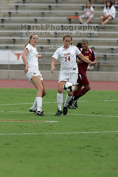 UT freshman Lucy Keith (#6, Midfielder) and UT senior Kasey Moore (#14, Defender) rush to the ball.  The University of Texas women's soccer team won 2-1 against the Iowa State Cyclones Sunday afternoon, October 5, 2008.

Filename: SRM_20081005_12023012.jpg
Aperture: f/5.6
Shutter Speed: 1/1600
Body: Canon EOS-1D Mark II
Lens: Canon EF 300mm f/2.8 L IS