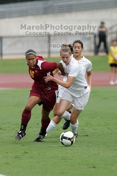 UT senior Stephanie Logterman (#10, Defender) and UT junior Emily Anderson (#21, Forward) team up on Iowa State #16.  The University of Texas women's soccer team won 2-1 against the Iowa State Cyclones Sunday afternoon, October 5, 2008.

Filename: SRM_20081005_12051854.jpg
Aperture: f/5.6
Shutter Speed: 1/1250
Body: Canon EOS-1D Mark II
Lens: Canon EF 300mm f/2.8 L IS