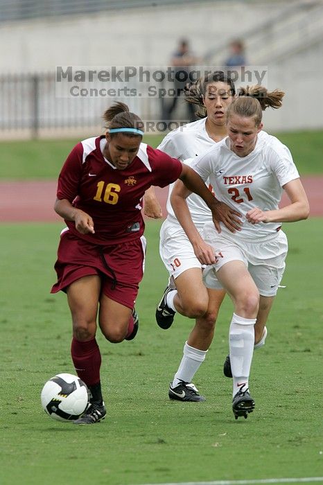 UT senior Stephanie Logterman (#10, Defender) and UT junior Emily Anderson (#21, Forward) team up on Iowa State #16.  The University of Texas women's soccer team won 2-1 against the Iowa State Cyclones Sunday afternoon, October 5, 2008.

Filename: SRM_20081005_12052058.jpg
Aperture: f/5.6
Shutter Speed: 1/1250
Body: Canon EOS-1D Mark II
Lens: Canon EF 300mm f/2.8 L IS