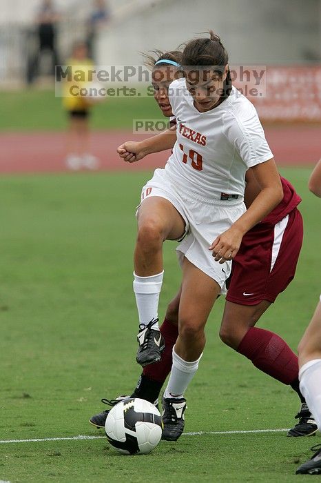 UT senior Stephanie Logterman (#10, Defender) and UT junior Emily Anderson (#21, Forward) team up on Iowa State #16.  The University of Texas women's soccer team won 2-1 against the Iowa State Cyclones Sunday afternoon, October 5, 2008.

Filename: SRM_20081005_12052471.jpg
Aperture: f/5.6
Shutter Speed: 1/1600
Body: Canon EOS-1D Mark II
Lens: Canon EF 300mm f/2.8 L IS