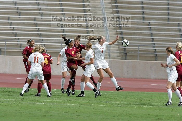 UT freshman Lucy Keith (#6, Midfielder) goes up for the header as UT freshman Kylie Doniak (#15, Midfielder), UT senior Kasey Moore (#14, Defender), and UT sophomore Niki Arlitt (#11, Forward) watch.  The University of Texas women's soccer team won 2-1 against the Iowa State Cyclones Sunday afternoon, October 5, 2008.

Filename: SRM_20081005_12072496.jpg
Aperture: f/5.6
Shutter Speed: 1/1600
Body: Canon EOS-1D Mark II
Lens: Canon EF 300mm f/2.8 L IS