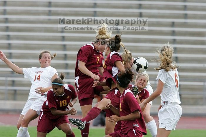 UT freshman Courtney Goodson (#7, Forward and Midfielder) attempts a header while UT senior Kasey Moore (#14, Defender) and UT freshman Lucy Keith (#6, Midfielder) watch.  The University of Texas women's soccer team won 2-1 against the Iowa State Cyclones Sunday afternoon, October 5, 2008.

Filename: SRM_20081005_12235034.jpg
Aperture: f/5.6
Shutter Speed: 1/1000
Body: Canon EOS-1D Mark II
Lens: Canon EF 300mm f/2.8 L IS