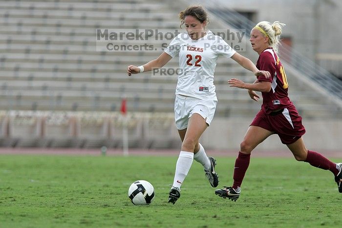 UT junior Stephanie Gibson (#22, Defense and Forward) steals the ball from an Iowa State player.  The University of Texas women's soccer team won 2-1 against the Iowa State Cyclones Sunday afternoon, October 5, 2008.

Filename: SRM_20081005_12364655.jpg
Aperture: f/5.6
Shutter Speed: 1/1250
Body: Canon EOS-1D Mark II
Lens: Canon EF 300mm f/2.8 L IS