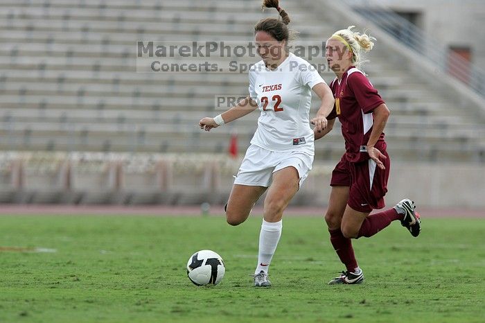 UT junior Stephanie Gibson (#22, Defense and Forward) steals the ball from an Iowa State player.  The University of Texas women's soccer team won 2-1 against the Iowa State Cyclones Sunday afternoon, October 5, 2008.

Filename: SRM_20081005_12364656.jpg
Aperture: f/5.6
Shutter Speed: 1/1250
Body: Canon EOS-1D Mark II
Lens: Canon EF 300mm f/2.8 L IS