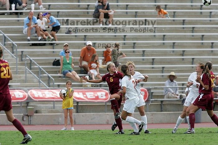 UT sophomore Kirsten Birkhold (#2, Forward and Midfielder) and UT sophomore Kate Nicholson (#17, Forward and Midfielder) fight for the header as UT junior Stephanie Gibson (#22, Defense and Forward) watches.  The University of Texas women's soccer team won 2-1 against the Iowa State Cyclones Sunday afternoon, October 5, 2008.

Filename: SRM_20081005_12410000.jpg
Aperture: f/5.6
Shutter Speed: 1/1250
Body: Canon EOS-1D Mark II
Lens: Canon EF 300mm f/2.8 L IS