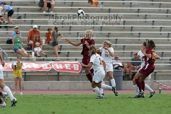 UT sophomore Kirsten Birkhold (#2, Forward and Midfielder) and UT sophomore Kate Nicholson (#17, Forward and Midfielder) fight for the header as UT junior Stephanie Gibson (#22, Defense and Forward) watches.  The University of Texas women's soccer team won 2-1 against the Iowa State Cyclones Sunday afternoon, October 5, 2008.

Filename: SRM_20081005_12410097.jpg
Aperture: f/5.6
Shutter Speed: 1/1250
Body: Canon EOS-1D Mark II
Lens: Canon EF 300mm f/2.8 L IS