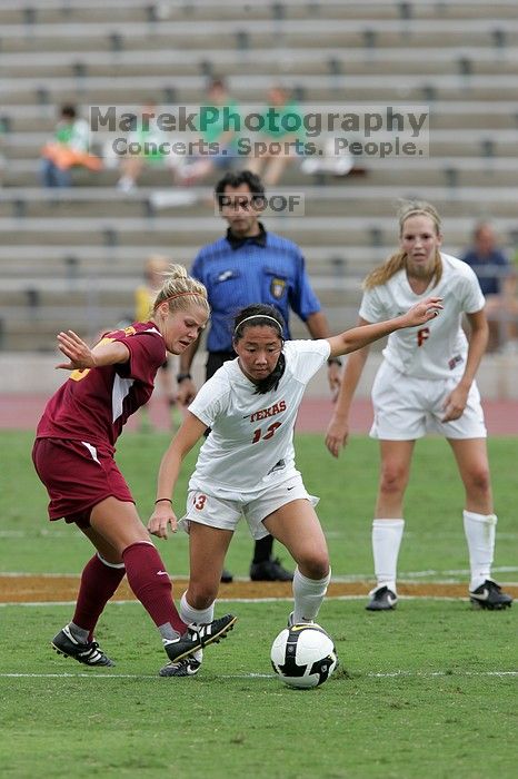 UT freshman Amanda Lisberger (#13, Midfielder) steals the ball as UT freshman Lucy Keith (#6, Midfielder) watches in the second half.  The University of Texas women's soccer team won 2-1 against the Iowa State Cyclones Sunday afternoon, October 5, 2008.

Filename: SRM_20081005_13335669.jpg
Aperture: f/5.6
Shutter Speed: 1/1250
Body: Canon EOS-1D Mark II
Lens: Canon EF 300mm f/2.8 L IS