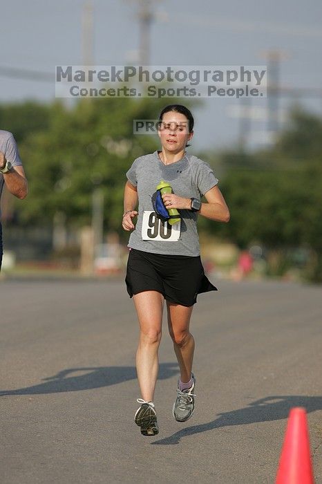 Beth Marek won first place in her age division at the Army Dillo half-marathon and 32K race.

Filename: SRM_20080921_0841362.jpg
Aperture: f/4.0
Shutter Speed: 1/2000
Body: Canon EOS-1D Mark II
Lens: Canon EF 300mm f/2.8 L IS