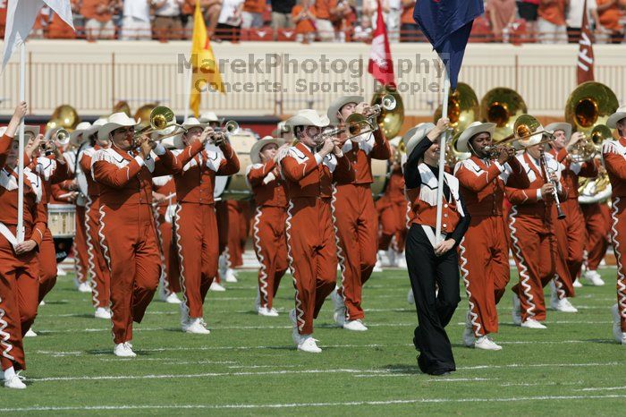 The UT marching band takes the field before the Arkansas football game.  The University of Texas football team defeated the Arkansas Razorbacks with a score of 52-10 in Austin, TX on Saturday, September 27, 2008.

Filename: SRM_20080927_14193412.jpg
Aperture: f/5.6
Shutter Speed: 1/1600
Body: Canon EOS-1D Mark II
Lens: Canon EF 300mm f/2.8 L IS