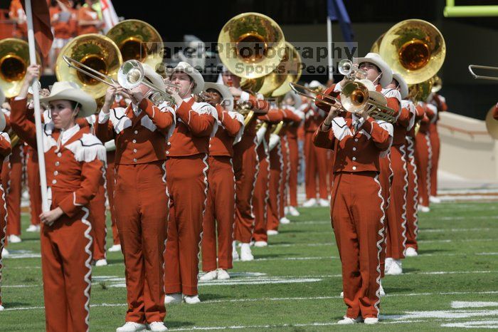 The UT marching band takes the field before the Arkansas football game.  The University of Texas football team defeated the Arkansas Razorbacks with a score of 52-10 in Austin, TX on Saturday, September 27, 2008.

Filename: SRM_20080927_14195820.jpg
Aperture: f/5.6
Shutter Speed: 1/1600
Body: Canon EOS-1D Mark II
Lens: Canon EF 300mm f/2.8 L IS