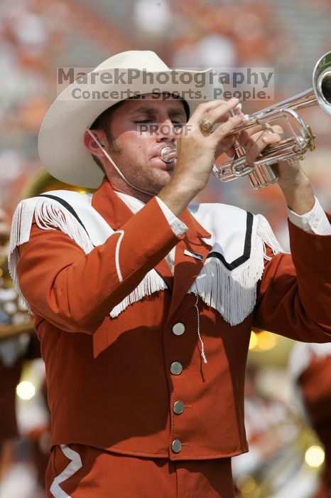 The UT marching band takes the field before the Arkansas football game.  The University of Texas football team defeated the Arkansas Razorbacks with a score of 52-10 in Austin, TX on Saturday, September 27, 2008.

Filename: SRM_20080927_14203034.jpg
Aperture: f/5.6
Shutter Speed: 1/1600
Body: Canon EOS-1D Mark II
Lens: Canon EF 300mm f/2.8 L IS