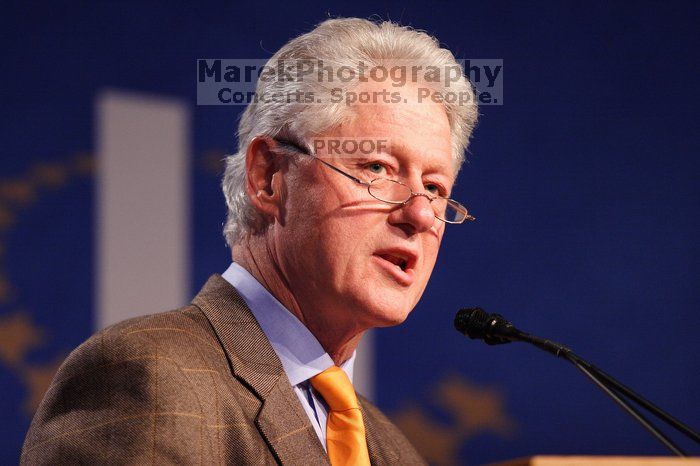 Former President Bill Clinton hands out commitment certificates to CGIU attendees for their exceptional pledges to the CGI cause during the opening plenary session of the CGIU meeting.  Day one of the 2nd Annual Clinton Global Initiative University (CGIU) meeting was held at The University of Texas at Austin, Friday, February 13, 2009.

Filename: SRM_20090213_16365866.jpg
Aperture: f/2.8
Shutter Speed: 1/200
Body: Canon EOS 20D
Lens: Canon EF 300mm f/2.8 L IS