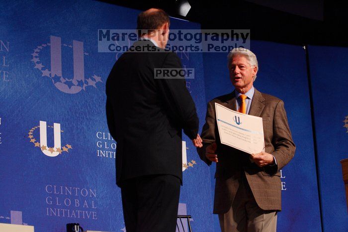 Former President Bill Clinton hands out commitment certificates to CGIU attendees for their exceptional pledges to the CGI cause during the opening plenary session of the CGIU meeting.  Day one of the 2nd Annual Clinton Global Initiative University (CGIU) meeting was held at The University of Texas at Austin, Friday, February 13, 2009.

Filename: SRM_20090213_16401335.jpg
Aperture: f/4.0
Shutter Speed: 1/200
Body: Canon EOS-1D Mark II
Lens: Canon EF 80-200mm f/2.8 L