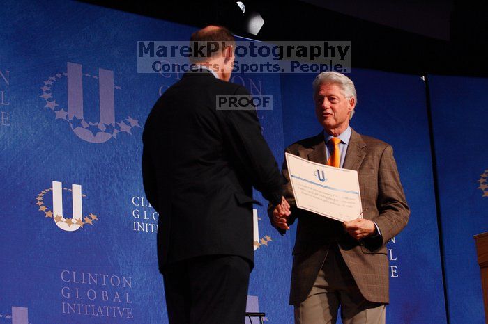 Former President Bill Clinton hands out commitment certificates to CGIU attendees for their exceptional pledges to the CGI cause during the opening plenary session of the CGIU meeting.  Day one of the 2nd Annual Clinton Global Initiative University (CGIU) meeting was held at The University of Texas at Austin, Friday, February 13, 2009.

Filename: SRM_20090213_16401336.jpg
Aperture: f/4.0
Shutter Speed: 1/200
Body: Canon EOS-1D Mark II
Lens: Canon EF 80-200mm f/2.8 L