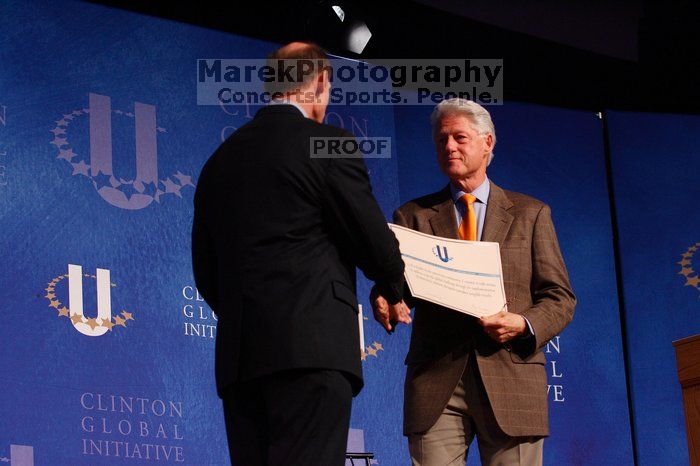 Former President Bill Clinton hands out commitment certificates to CGIU attendees for their exceptional pledges to the CGI cause during the opening plenary session of the CGIU meeting.  Day one of the 2nd Annual Clinton Global Initiative University (CGIU) meeting was held at The University of Texas at Austin, Friday, February 13, 2009.

Filename: SRM_20090213_16401337.jpg
Aperture: f/4.0
Shutter Speed: 1/200
Body: Canon EOS-1D Mark II
Lens: Canon EF 80-200mm f/2.8 L