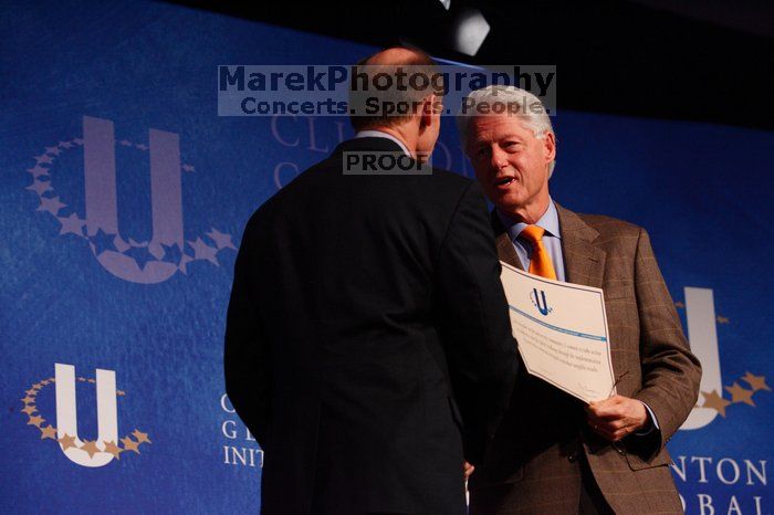 Former President Bill Clinton hands out commitment certificates to CGIU attendees for their exceptional pledges to the CGI cause during the opening plenary session of the CGIU meeting.  Day one of the 2nd Annual Clinton Global Initiative University (CGIU) meeting was held at The University of Texas at Austin, Friday, February 13, 2009.

Filename: SRM_20090213_16401439.jpg
Aperture: f/4.0
Shutter Speed: 1/200
Body: Canon EOS-1D Mark II
Lens: Canon EF 80-200mm f/2.8 L