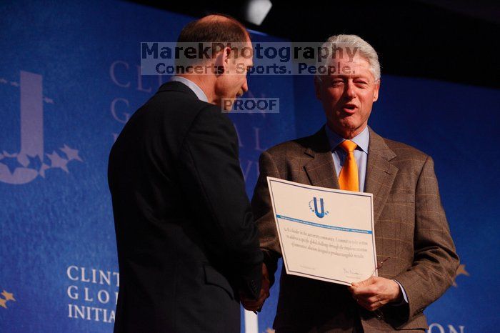 Former President Bill Clinton hands out commitment certificates to CGIU attendees for their exceptional pledges to the CGI cause during the opening plenary session of the CGIU meeting.  Day one of the 2nd Annual Clinton Global Initiative University (CGIU) meeting was held at The University of Texas at Austin, Friday, February 13, 2009.

Filename: SRM_20090213_16401542.jpg
Aperture: f/4.0
Shutter Speed: 1/200
Body: Canon EOS-1D Mark II
Lens: Canon EF 80-200mm f/2.8 L