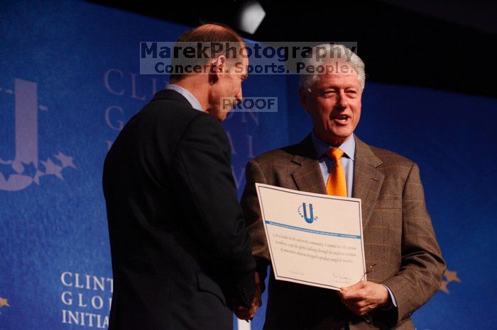 Former President Bill Clinton hands out commitment certificates to CGIU attendees for their exceptional pledges to the CGI cause during the opening plenary session of the CGIU meeting.  Day one of the 2nd Annual Clinton Global Initiative University (CGIU) meeting was held at The University of Texas at Austin, Friday, February 13, 2009.

Filename: SRM_20090213_16401543.jpg
Aperture: f/4.0
Shutter Speed: 1/200
Body: Canon EOS-1D Mark II
Lens: Canon EF 80-200mm f/2.8 L