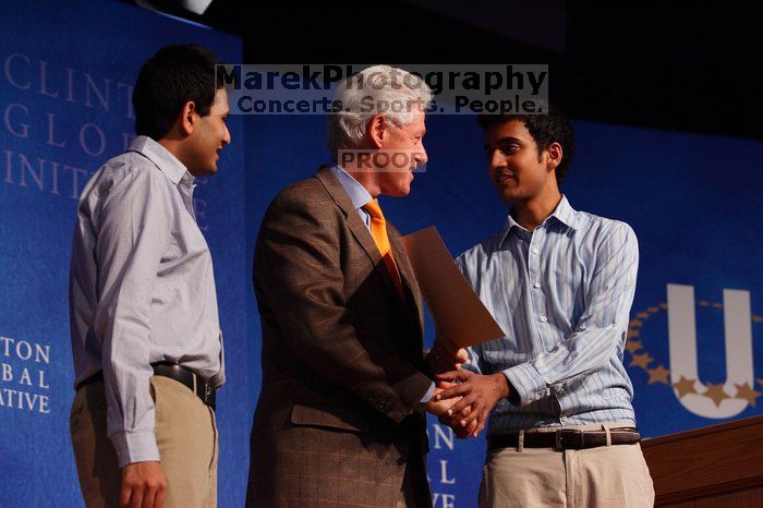 Former President Bill Clinton hands out commitment certificates to CGIU attendees for their exceptional pledges to the CGI cause during the opening plenary session of the CGIU meeting.  Day one of the 2nd Annual Clinton Global Initiative University (CGIU) meeting was held at The University of Texas at Austin, Friday, February 13, 2009.

Filename: SRM_20090213_16425280.jpg
Aperture: f/4.0
Shutter Speed: 1/200
Body: Canon EOS-1D Mark II
Lens: Canon EF 80-200mm f/2.8 L