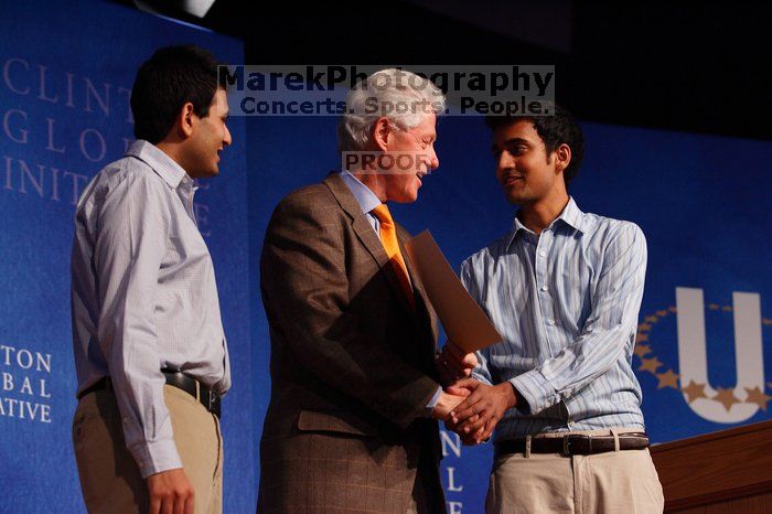 Former President Bill Clinton hands out commitment certificates to CGIU attendees for their exceptional pledges to the CGI cause during the opening plenary session of the CGIU meeting.  Day one of the 2nd Annual Clinton Global Initiative University (CGIU) meeting was held at The University of Texas at Austin, Friday, February 13, 2009.

Filename: SRM_20090213_16425281.jpg
Aperture: f/4.0
Shutter Speed: 1/200
Body: Canon EOS-1D Mark II
Lens: Canon EF 80-200mm f/2.8 L