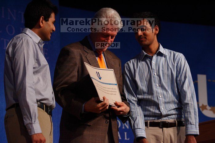 Former President Bill Clinton hands out commitment certificates to CGIU attendees for their exceptional pledges to the CGI cause during the opening plenary session of the CGIU meeting.  Day one of the 2nd Annual Clinton Global Initiative University (CGIU) meeting was held at The University of Texas at Austin, Friday, February 13, 2009.

Filename: SRM_20090213_16425383.jpg
Aperture: f/4.0
Shutter Speed: 1/250
Body: Canon EOS-1D Mark II
Lens: Canon EF 80-200mm f/2.8 L