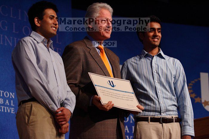 Former President Bill Clinton hands out commitment certificates to CGIU attendees for their exceptional pledges to the CGI cause during the opening plenary session of the CGIU meeting.  Day one of the 2nd Annual Clinton Global Initiative University (CGIU) meeting was held at The University of Texas at Austin, Friday, February 13, 2009.

Filename: SRM_20090213_16425585.jpg
Aperture: f/4.0
Shutter Speed: 1/250
Body: Canon EOS-1D Mark II
Lens: Canon EF 80-200mm f/2.8 L