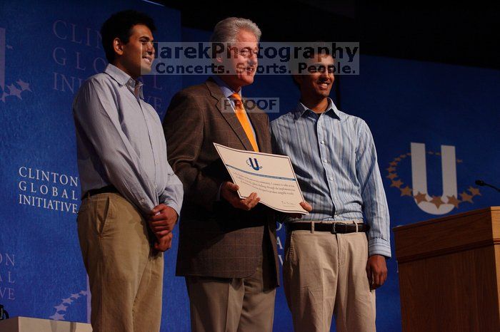 Former President Bill Clinton hands out commitment certificates to CGIU attendees for their exceptional pledges to the CGI cause during the opening plenary session of the CGIU meeting.  Day one of the 2nd Annual Clinton Global Initiative University (CGIU) meeting was held at The University of Texas at Austin, Friday, February 13, 2009.

Filename: SRM_20090213_16425787.jpg
Aperture: f/4.0
Shutter Speed: 1/320
Body: Canon EOS-1D Mark II
Lens: Canon EF 80-200mm f/2.8 L