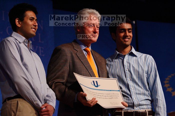 Former President Bill Clinton hands out commitment certificates to CGIU attendees for their exceptional pledges to the CGI cause during the opening plenary session of the CGIU meeting.  Day one of the 2nd Annual Clinton Global Initiative University (CGIU) meeting was held at The University of Texas at Austin, Friday, February 13, 2009.

Filename: SRM_20090213_16430090.jpg
Aperture: f/4.0
Shutter Speed: 1/250
Body: Canon EOS-1D Mark II
Lens: Canon EF 80-200mm f/2.8 L