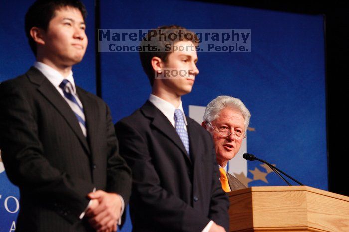 Former President Bill Clinton hands out commitment certificates to CGIU attendees for their exceptional pledges to the CGI cause during the opening plenary session of the CGIU meeting.  Day one of the 2nd Annual Clinton Global Initiative University (CGIU) meeting was held at The University of Texas at Austin, Friday, February 13, 2009.

Filename: SRM_20090213_16452208.jpg
Aperture: f/4.0
Shutter Speed: 1/125
Body: Canon EOS-1D Mark II
Lens: Canon EF 80-200mm f/2.8 L