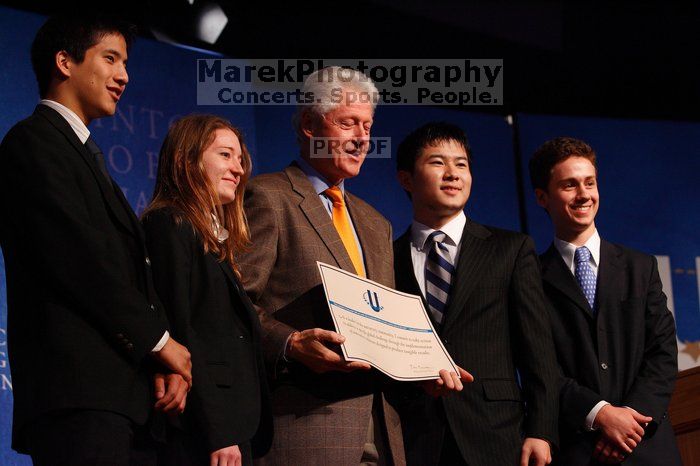 Former President Bill Clinton hands out commitment certificates to CGIU attendees for their exceptional pledges to the CGI cause during the opening plenary session of the CGIU meeting.  Day one of the 2nd Annual Clinton Global Initiative University (CGIU) meeting was held at The University of Texas at Austin, Friday, February 13, 2009.

Filename: SRM_20090213_16473741.jpg
Aperture: f/4.0
Shutter Speed: 1/200
Body: Canon EOS-1D Mark II
Lens: Canon EF 80-200mm f/2.8 L