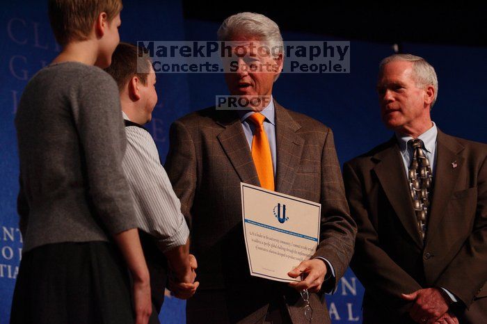 Former President Bill Clinton hands out commitment certificates to CGIU attendees for their exceptional pledges to the CGI cause during the opening plenary session of the CGIU meeting.  Day one of the 2nd Annual Clinton Global Initiative University (CGIU) meeting was held at The University of Texas at Austin, Friday, February 13, 2009.

Filename: SRM_20090213_16504874.jpg
Aperture: f/4.0
Shutter Speed: 1/250
Body: Canon EOS-1D Mark II
Lens: Canon EF 80-200mm f/2.8 L