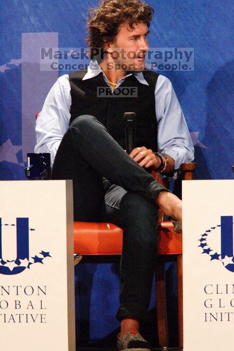 Blake Mycoskie, founder of TOMS shoes, donates one pair of shoes to a third world country for every pair of shoes they sell.  Day one of the 2nd Annual Clinton Global Initiative University (CGIU) meeting was held at The University of Texas at Austin, Friday, February 13, 2009.

Filename: SRM_20090213_17311391.jpg
Aperture: f/5.6
Shutter Speed: 1/200
Body: Canon EOS-1D Mark II
Lens: Canon EF 300mm f/2.8 L IS