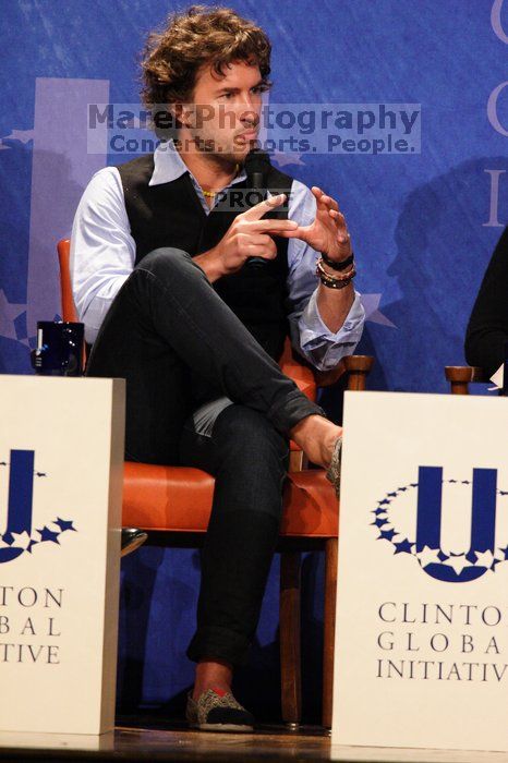 Blake Mycoskie, founder of TOMS shoes, donates one pair of shoes to a third world country for every pair of shoes they sell.  Day one of the 2nd Annual Clinton Global Initiative University (CGIU) meeting was held at The University of Texas at Austin, Friday, February 13, 2009.

Filename: SRM_20090213_17340996.jpg
Aperture: f/5.6
Shutter Speed: 1/200
Body: Canon EOS 20D
Lens: Canon EF 300mm f/2.8 L IS