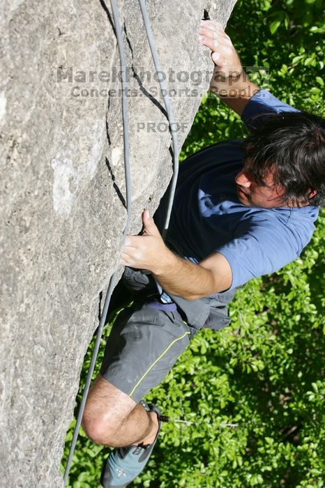 Javier Morales top rope climbing She's No Dog, She's My Wife (5.11b), shot from the top of Ack! (5.11b, but using the crack for the start instead) that I top roped up with my camera on my back.  It was another long day of rock climbing at Seismic Wall on Austin's Barton Creek Greenbelt, Sunday, April 5, 2009.

Filename: SRM_20090405_16173308.jpg
Aperture: f/10.0
Shutter Speed: 1/500
Body: Canon EOS-1D Mark II
Lens: Canon EF 80-200mm f/2.8 L