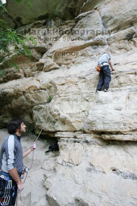 Andrew Dreher lead climbing Magster (5.10a) with Javier Morales belaying.  It was another long day of rock climbing at Seismic Wall on Austin's Barton Creek Greenbelt, Saturday, April 11, 2009.

Filename: SRM_20090411_15292378.JPG
Aperture: f/4.0
Shutter Speed: 1/250
Body: Canon EOS-1D Mark II
Lens: Canon EF 16-35mm f/2.8 L