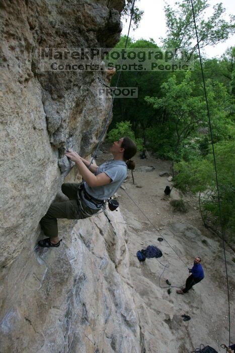 Hannah Norton top rope climbing Diving for Rocks (5.10d), photographed from  the third bolt of Magster (5.10a).  It was another long day of rock climbing at Seismic Wall on Austin's Barton Creek Greenbelt, Saturday, April 11, 2009.

Filename: SRM_20090411_16102842.JPG
Aperture: f/5.0
Shutter Speed: 1/250
Body: Canon EOS-1D Mark II
Lens: Canon EF 16-35mm f/2.8 L