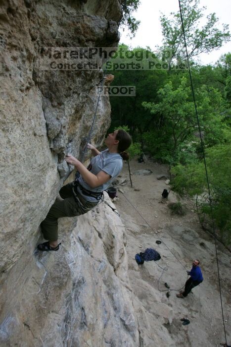 Hannah Norton top rope climbing Diving for Rocks (5.10d), photographed from  the third bolt of Magster (5.10a).  It was another long day of rock climbing at Seismic Wall on Austin's Barton Creek Greenbelt, Saturday, April 11, 2009.

Filename: SRM_20090411_16102843.JPG
Aperture: f/5.0
Shutter Speed: 1/250
Body: Canon EOS-1D Mark II
Lens: Canon EF 16-35mm f/2.8 L