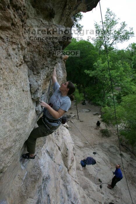 Hannah Norton top rope climbing Diving for Rocks (5.10d), photographed from  the third bolt of Magster (5.10a).  It was another long day of rock climbing at Seismic Wall on Austin's Barton Creek Greenbelt, Saturday, April 11, 2009.

Filename: SRM_20090411_16102845.JPG
Aperture: f/5.0
Shutter Speed: 1/250
Body: Canon EOS-1D Mark II
Lens: Canon EF 16-35mm f/2.8 L