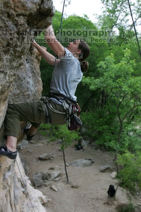 Hannah Norton top rope climbing Diving for Rocks (5.10d), photographed from  the third bolt of Magster (5.10a).  It was another long day of rock climbing at Seismic Wall on Austin's Barton Creek Greenbelt, Saturday, April 11, 2009.

Filename: SRM_20090411_16112259.JPG
Aperture: f/4.0
Shutter Speed: 1/250
Body: Canon EOS-1D Mark II
Lens: Canon EF 16-35mm f/2.8 L