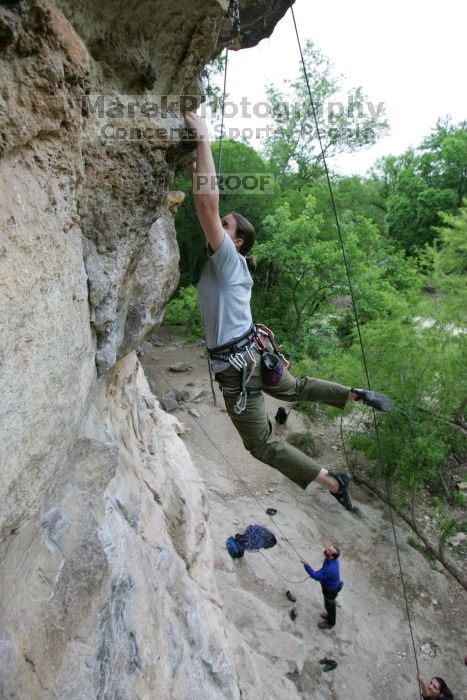 Hannah Norton top rope climbing Diving for Rocks (5.10d), photographed from  the third bolt of Magster (5.10a).  It was another long day of rock climbing at Seismic Wall on Austin's Barton Creek Greenbelt, Saturday, April 11, 2009.

Filename: SRM_20090411_16134169.JPG
Aperture: f/4.0
Shutter Speed: 1/250
Body: Canon EOS-1D Mark II
Lens: Canon EF 16-35mm f/2.8 L