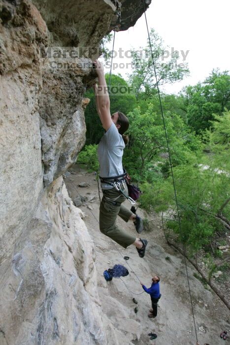 Hannah Norton top rope climbing Diving for Rocks (5.10d), photographed from  the third bolt of Magster (5.10a).  It was another long day of rock climbing at Seismic Wall on Austin's Barton Creek Greenbelt, Saturday, April 11, 2009.

Filename: SRM_20090411_16134172.JPG
Aperture: f/4.0
Shutter Speed: 1/250
Body: Canon EOS-1D Mark II
Lens: Canon EF 16-35mm f/2.8 L