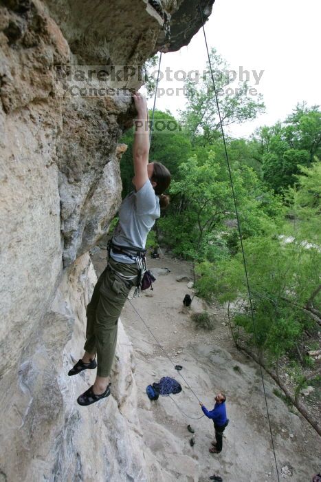 Hannah Norton top rope climbing Diving for Rocks (5.10d), photographed from  the third bolt of Magster (5.10a).  It was another long day of rock climbing at Seismic Wall on Austin's Barton Creek Greenbelt, Saturday, April 11, 2009.

Filename: SRM_20090411_16134274.JPG
Aperture: f/4.0
Shutter Speed: 1/250
Body: Canon EOS-1D Mark II
Lens: Canon EF 16-35mm f/2.8 L