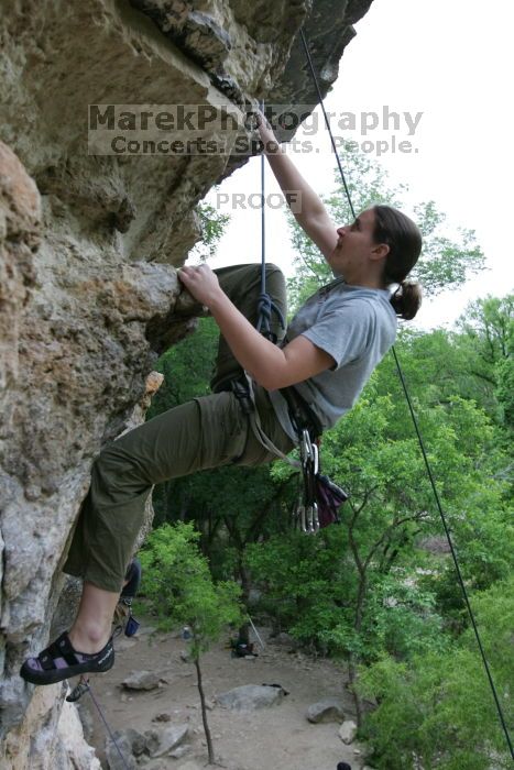 Hannah Norton top rope climbing Diving for Rocks (5.10d), photographed from  the third bolt of Magster (5.10a).  It was another long day of rock climbing at Seismic Wall on Austin's Barton Creek Greenbelt, Saturday, April 11, 2009.

Filename: SRM_20090411_16140580.JPG
Aperture: f/4.0
Shutter Speed: 1/250
Body: Canon EOS-1D Mark II
Lens: Canon EF 16-35mm f/2.8 L