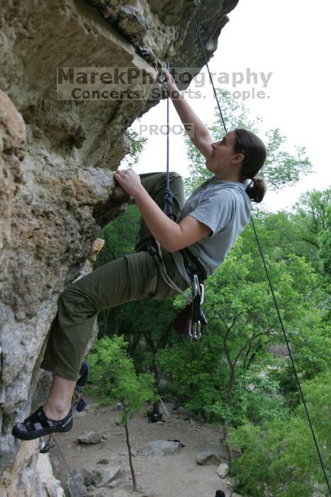 Hannah Norton top rope climbing Diving for Rocks (5.10d), photographed from  the third bolt of Magster (5.10a).  It was another long day of rock climbing at Seismic Wall on Austin's Barton Creek Greenbelt, Saturday, April 11, 2009.

Filename: SRM_20090411_16140581.JPG
Aperture: f/4.0
Shutter Speed: 1/250
Body: Canon EOS-1D Mark II
Lens: Canon EF 16-35mm f/2.8 L