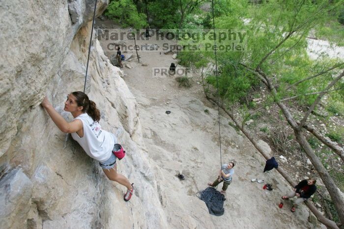 Charlotte Sanders top rope climbing Diving for Rocks (5.10d), photographed from  the third bolt of Magster (5.10a).  It was another long day of rock climbing at Seismic Wall on Austin's Barton Creek Greenbelt, Saturday, April 11, 2009.

Filename: SRM_20090411_16313143.JPG
Aperture: f/5.6
Shutter Speed: 1/320
Body: Canon EOS-1D Mark II
Lens: Canon EF 16-35mm f/2.8 L