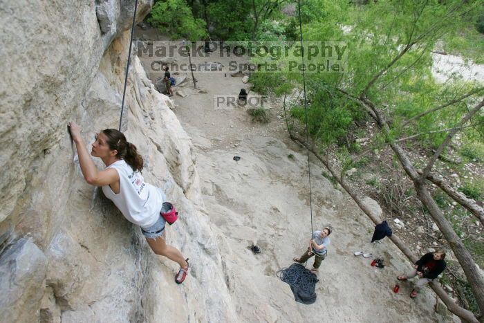 Charlotte Sanders top rope climbing Diving for Rocks (5.10d), photographed from  the third bolt of Magster (5.10a).  It was another long day of rock climbing at Seismic Wall on Austin's Barton Creek Greenbelt, Saturday, April 11, 2009.

Filename: SRM_20090411_16313244.JPG
Aperture: f/5.6
Shutter Speed: 1/320
Body: Canon EOS-1D Mark II
Lens: Canon EF 16-35mm f/2.8 L